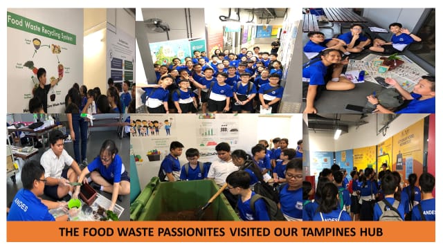 Students in blue uniforms visiting a food waste recycling hub, viewing displays and handling composting materials.